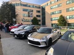 Car meetup at San Francisco State University with a crowd of people and various classic cars