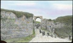 Tourists walking through the archway of Nolan Gate, ancient entrance to Pompeii city