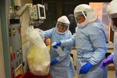 Military students practicing hazardous waste removal at Brook Army Medical Center for Ebola response