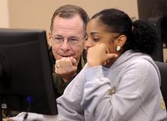 Chairman of the Joint Chiefs Adm. Mike Mullen discussing online college courses with Nain Gomez at Fort Sam Houston
