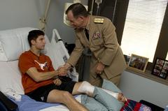 Admiral Mike Mullen presenting Purple Heart to Army Specialist David Reid at Brooke Army Medical Center