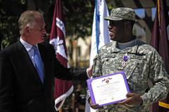 Deputy Secretary of Defense William J. Lynn III awarding Purple Heart to Pfc. Milton Jenkins at Brooke Army Medical Center ceremony