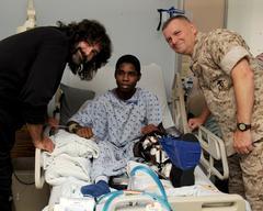 Professional wrestler Mick Foley and U.S. Marine Gen. James E. Cartwright with U.S. Army Spc. Andre Cook at Brooke Army Medical Center