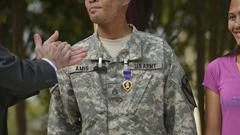 Deputy Secretary of Defense Ashton B. Carter applauding after awarding the Purple Heart medal to SSgt. Jerry Amis at Brook Army Medical Center
