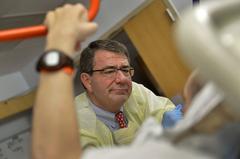 Deputy Secretary of Defense Ashton B. Carter listening to a wounded warrior at Brook Army Medical Center