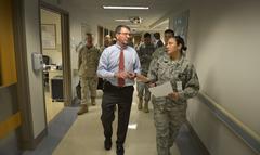 Senior Staff Sergeant Teresa Moldes guiding Deputy Secretary of Defense Ashton B. Carter through Brook Army Medical Center corridors