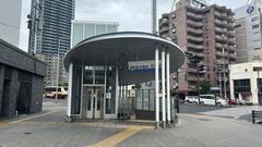 Hanshin Sakuragawa Station Exit 2 at street level with building and road