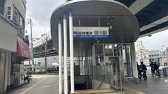 Hanshin Sakuragawa Station platform with train on tracks in Osaka, Japan