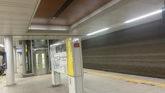 Hanshin Sakuragawa Station platform with railway tracks and overhead wires