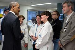 United States President Barack Obama talking with staff at Massachusetts General Hospital during a visit to meet victims of the 2013 Boston Marathon bombings