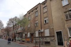 Charming street in Skadarlija, Belgrade with old buildings and a vintage car parked on the cobblestone road