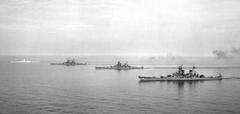 Four Iowa-class battleships in line abreast formation on the sea, 1954