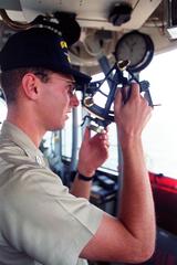 U.S. Navy officer aboard battleship USS Wisconsin using a sextant during Operation Desert Shield in January 1991