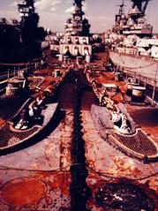 View from bow stem of USS Wisconsin looking aft at 16-inch gun turrets and superstructure with USS Intrepid and USS Iowa in mothball fleet at Philadelphia