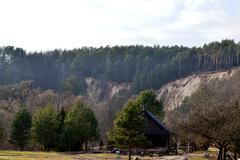 Pūčkoriai Crag in Lithuania with cliffs and river