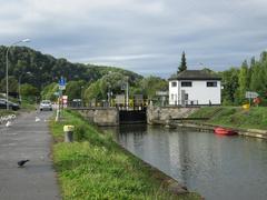 Güdingen weir with stone construction and flowing water under cloudy sky