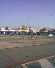 Danubia Shopping Center exterior view with a large parking lot