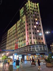 Night view of Palata Albanija building in Belgrade with illuminated windows and surrounding city lights