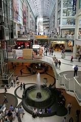 Eaton Centre shopping mall in Toronto with bustling crowd and city buildings