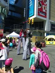 Performers on stilts at Buskerfest 2014 colorful costumes street performance