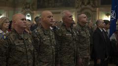General officers in the Armed Forces of Bosnia and Herzegovina standing for national anthem during NATO Headquarters Sarajevo transfer of authority ceremony