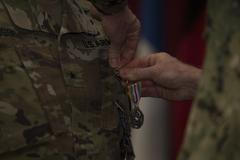 U.S. Navy Adm. James Foggo awarding Defense Superior Service Medal to U.S. Army Brig. Gen. Marti Bissell at NATO Headquarters Sarajevo transfer of authority ceremony