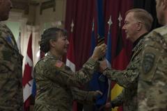 Transfer of authority ceremony at NATO Headquarters Sarajevo with U.S. Army Brig. Gen. Marti Bissell passing unit guidon to U.S. Navy Adm. James Foggo