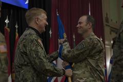U.S. Army Brig. Gen. William J. Edwards accepting unit guidon from U.S. Navy Adm. James Foggo during NATO transfer of authority ceremony in Sarajevo, Dec 12, 2019