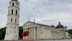 Two U.S. Air Force F-35 Lightning II jets and a KC-135 Stratotanker flying low over Cathedral Square in Vilnius, Lithuania