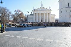 Four hearses escorting fallen U.S. soldiers stopping outside Vilnius Cathedral during a moment of silence