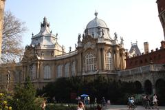 Vajdahunyad Castle in Budapest surrounded by lush green trees and clear blue sky