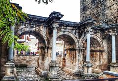 Ancient stone gate with archway surrounded by greenery