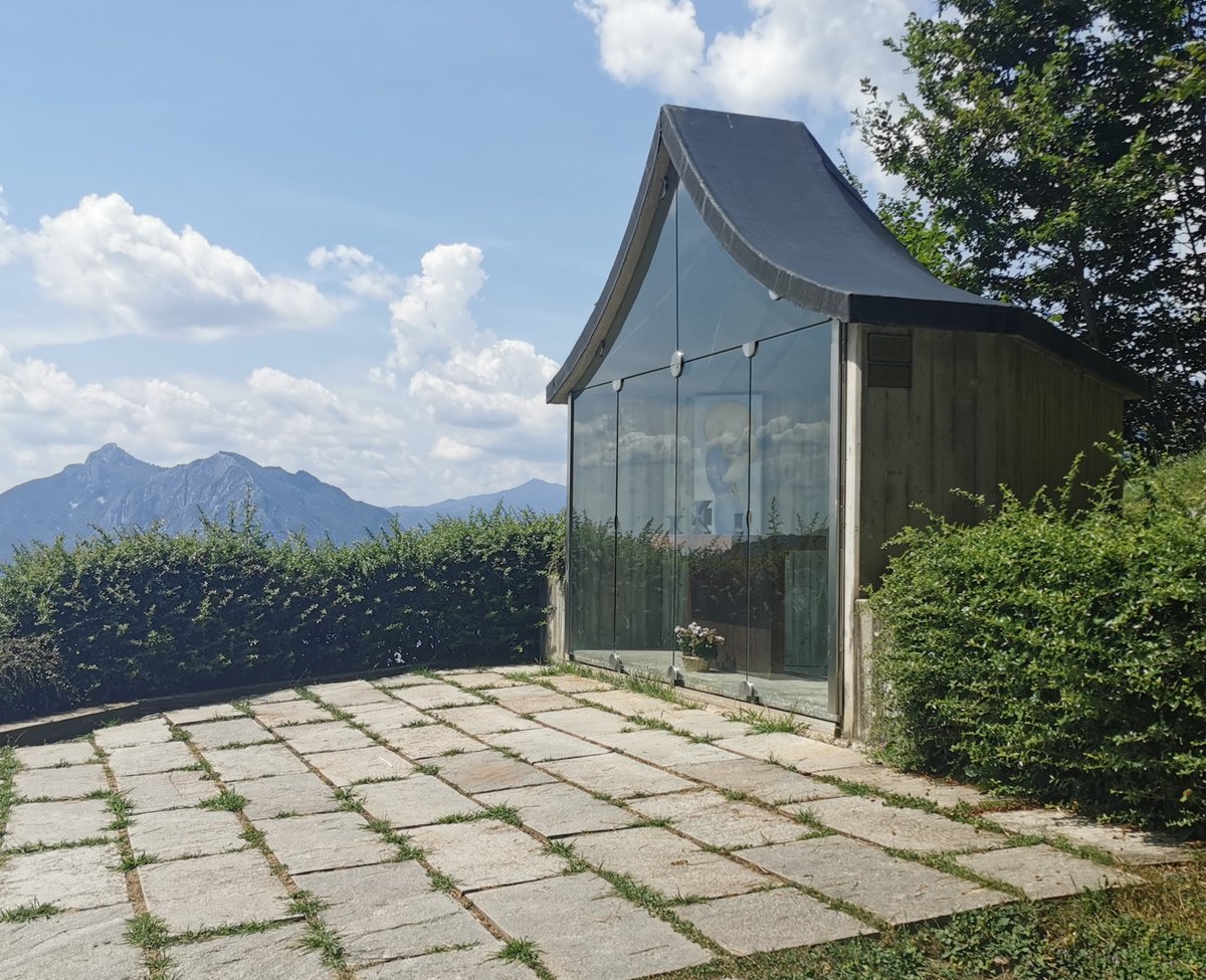 Madonna del Resegone statue with mountain backdrop in Lecco, Italy