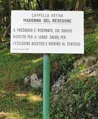 Madonna del Resegone signboard in Lecco with wooden background and religious image