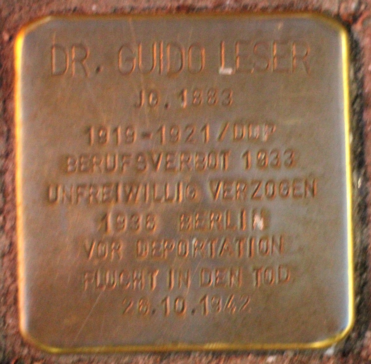 Stolperstein dedicated to Guido Leser in Karlsruhe, Germany, embedded in pavement outside a building