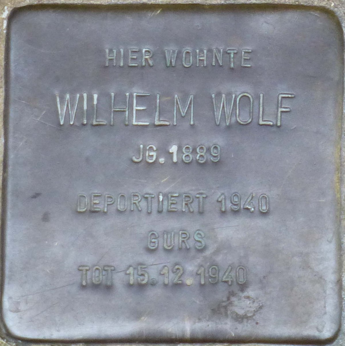 Stolperstein dedicated to Wilhelm Wolf in Karlsruhe, Germany embedded in pavement