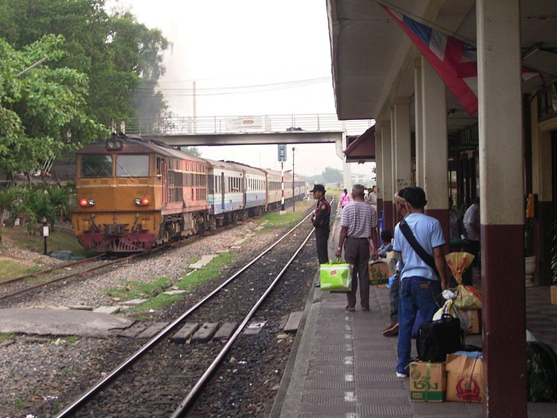 Bang Sue Junction Railway Station platform with trains and passengers in Thailand
