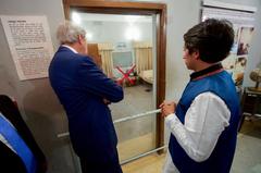 U.S. Secretary of State John Kerry observing a bedroom in Dhaka where a family was herded and killed