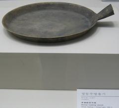 Stainless steel frypan on a gas stove in a kitchen
