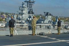 USNS Mercy hospital ship sailors rendering honors to USS Iowa Battleship museum at Port of Los Angeles