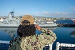 Operations Specialist 1st Class Alicia Griffin aboard hospital ship USNS Mercy saluting Battleship USS Iowa Museum at Port of Los Angeles