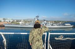 Operations Specialist 1st Class Alicia Griffin aboard hospital ship USNS Mercy saluting Battleship USS Iowa Museum at Port of Los Angeles during COVID-19 response, May 15, 2020