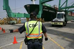 U.S. Customs and Border Protection officer directing a truck at Los Angeles seaport