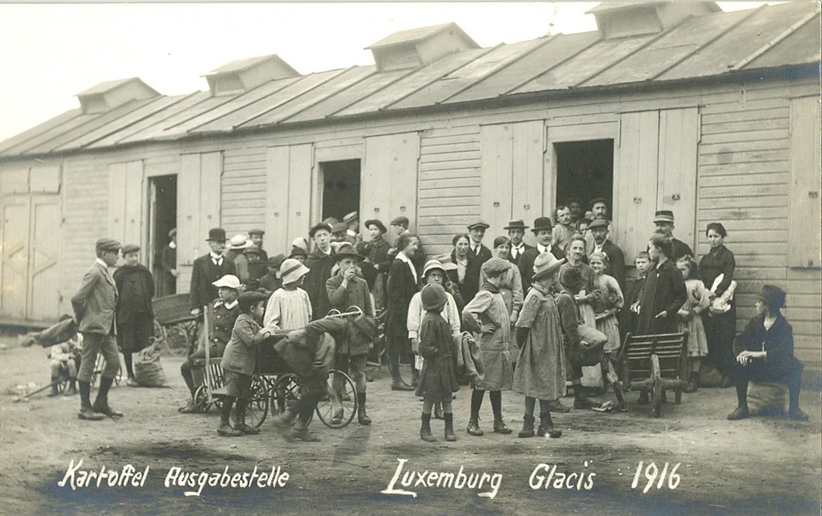 Potato distribution point during the 1916 food crisis at Glacis, Luxemburg with people waiting in line