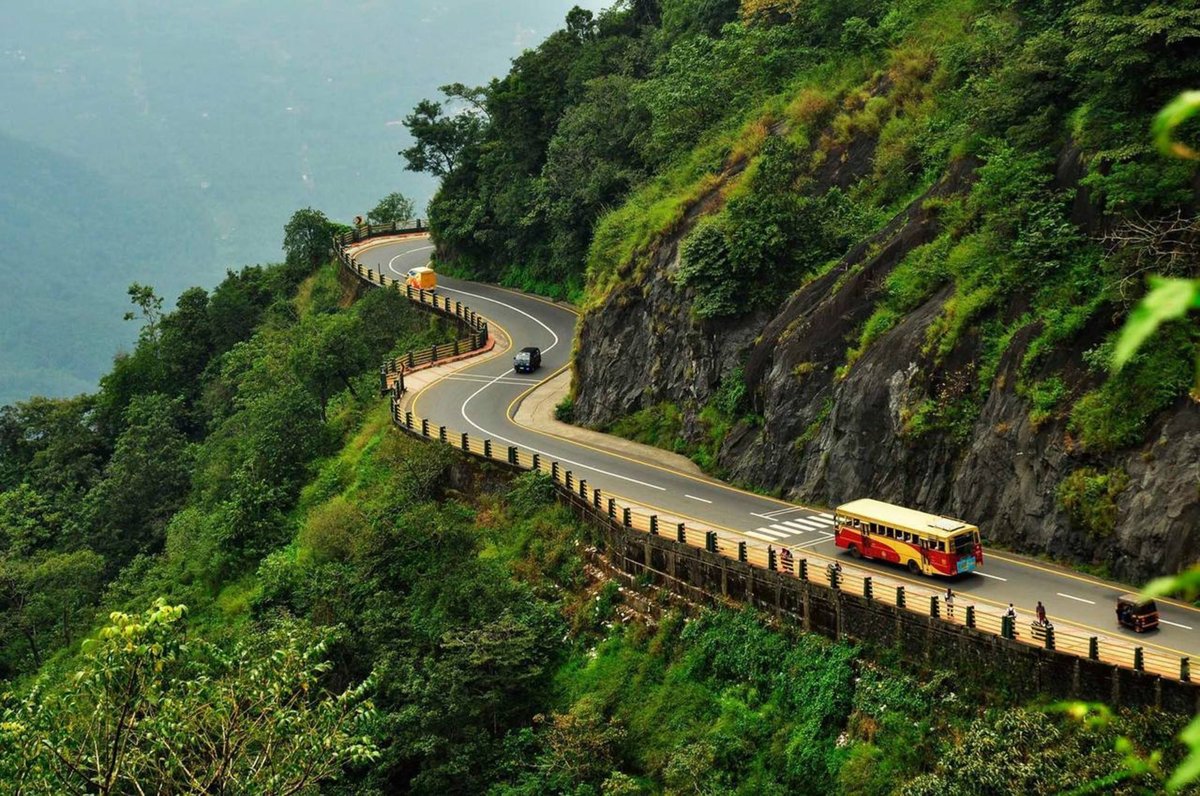 Scenic view of Thamarassery Churam mountain pass in Vythiri Taluk, India with lush green hills and winding road