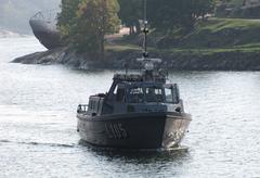 Finnish navy transport boat L105 docked in Tykistölahti bay with museum submarine Vesikko in background