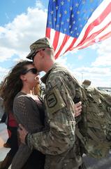 U.S. Army soldier embracing his wife at welcome home ceremony