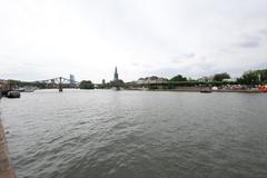 Iron Bridge (Eiserner Steg) in Frankfurt am Main over the Main river with city skyline in background