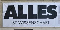 View of Deutsches Museum in Munich with the slogan 'Alles ist Wissenschaft' displayed on the building