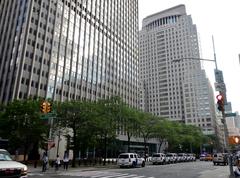 Broadway street with tall buildings and yellow taxis in New York City